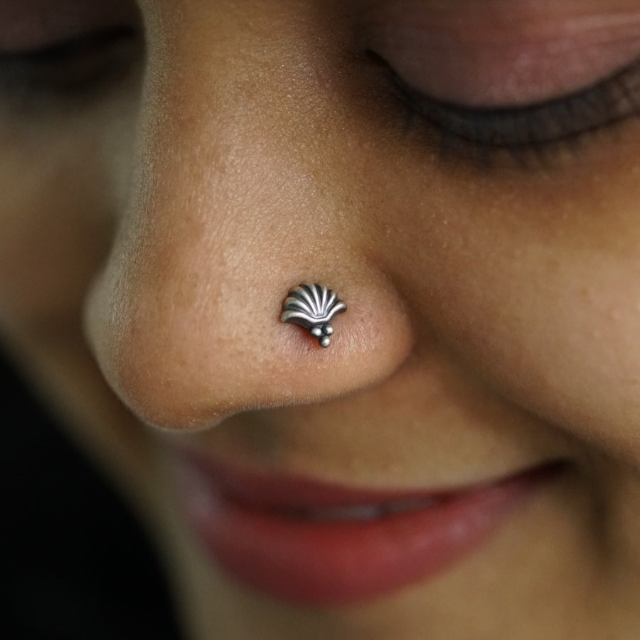 a close up of a person with a nose piercing