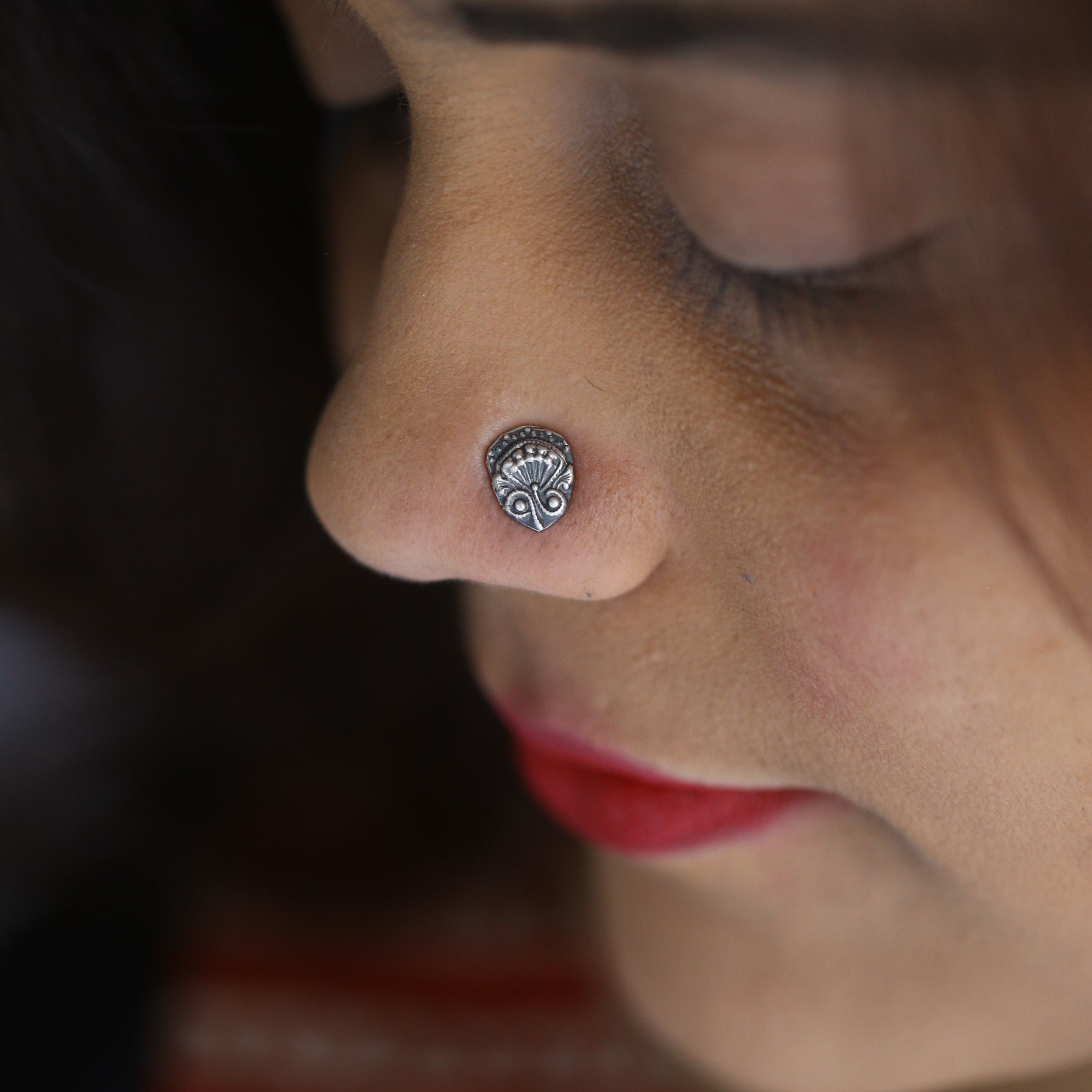 a close up of a person with a nose piercing