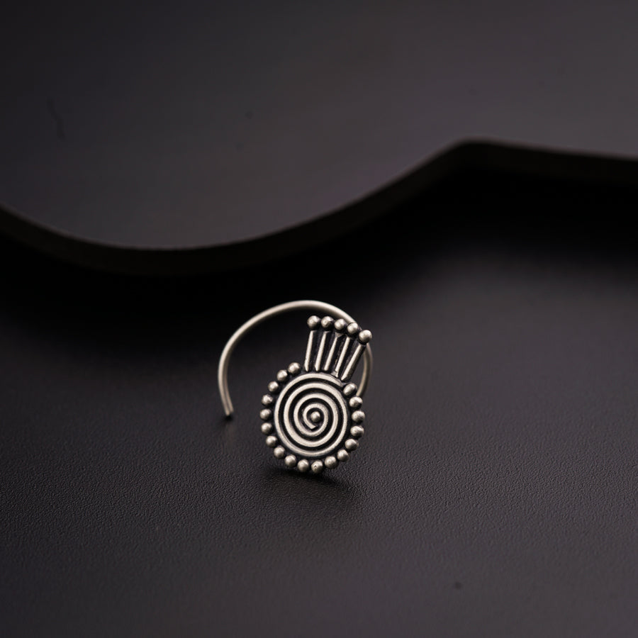 a silver ring with a spiral design on it