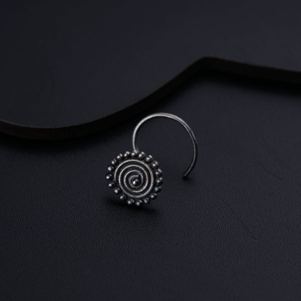 a pair of silver hoop earrings on a black surface