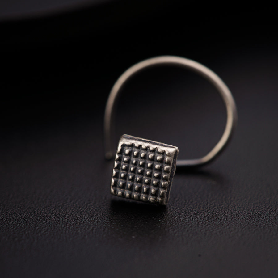 a silver ring with a square design on it