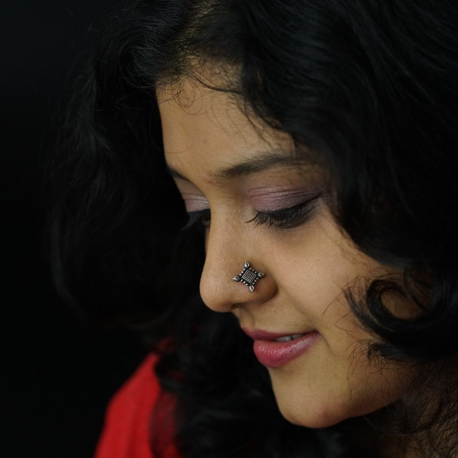 a close up of a woman with a nose piercing