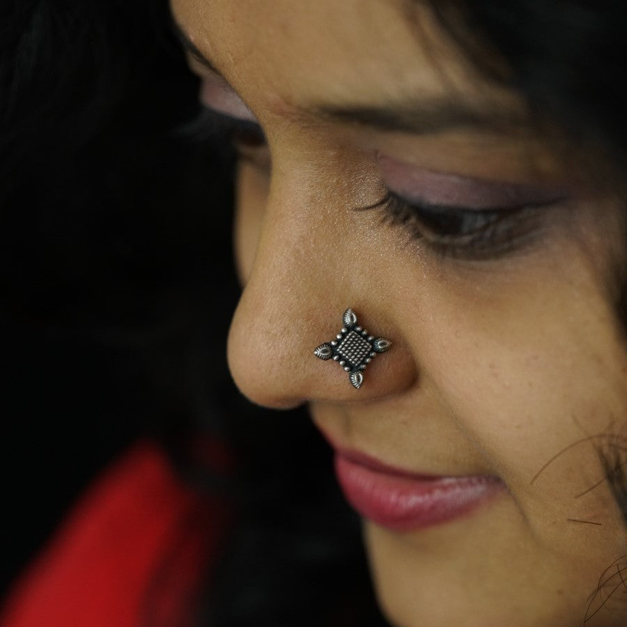 a close up of a person with a nose piercing