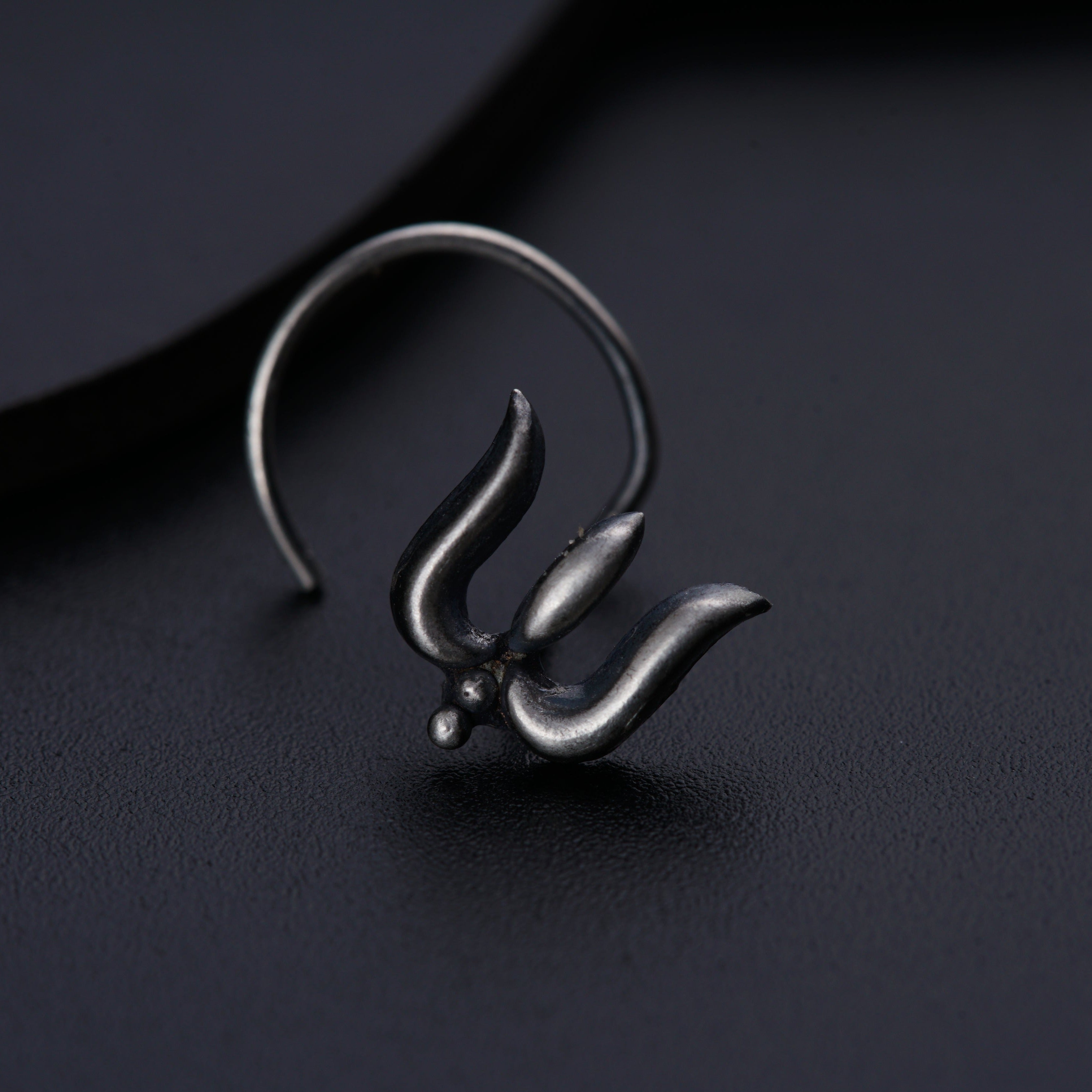 a close up of a metal object on a black surface