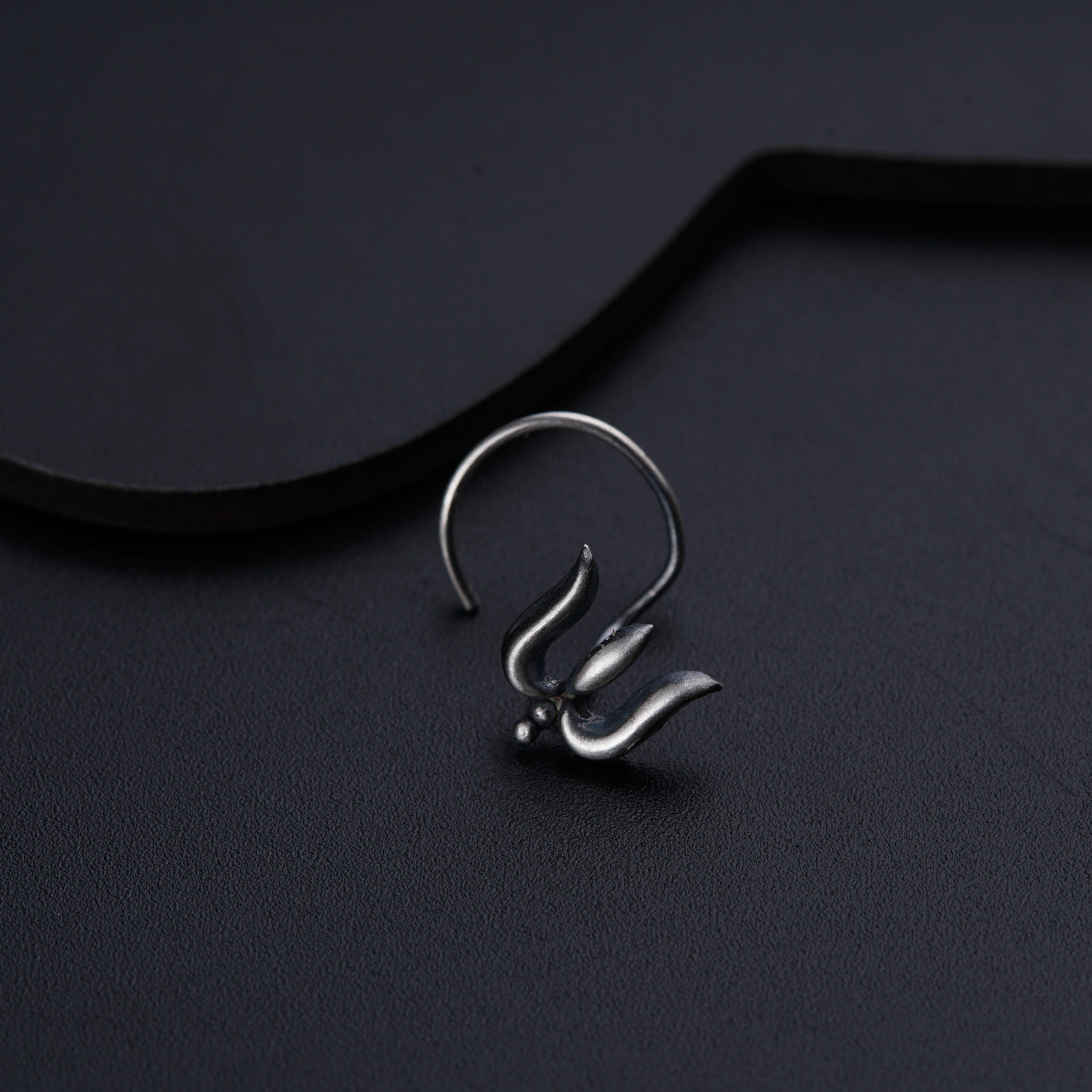 a close up of a metal object on a black surface