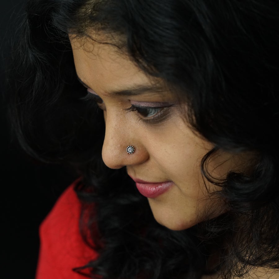 a close up of a woman with a nose ring