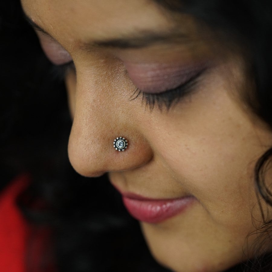 a close up of a woman with a nose piercing