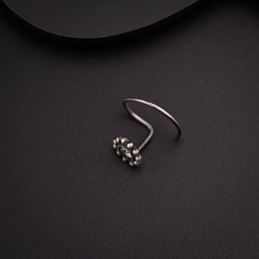 a close up of a pair of earrings on a black surface