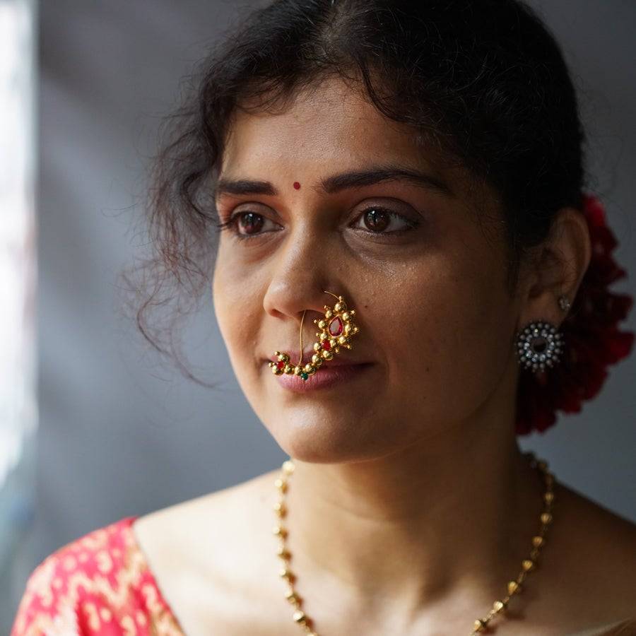 a close up of a woman with a nose ring