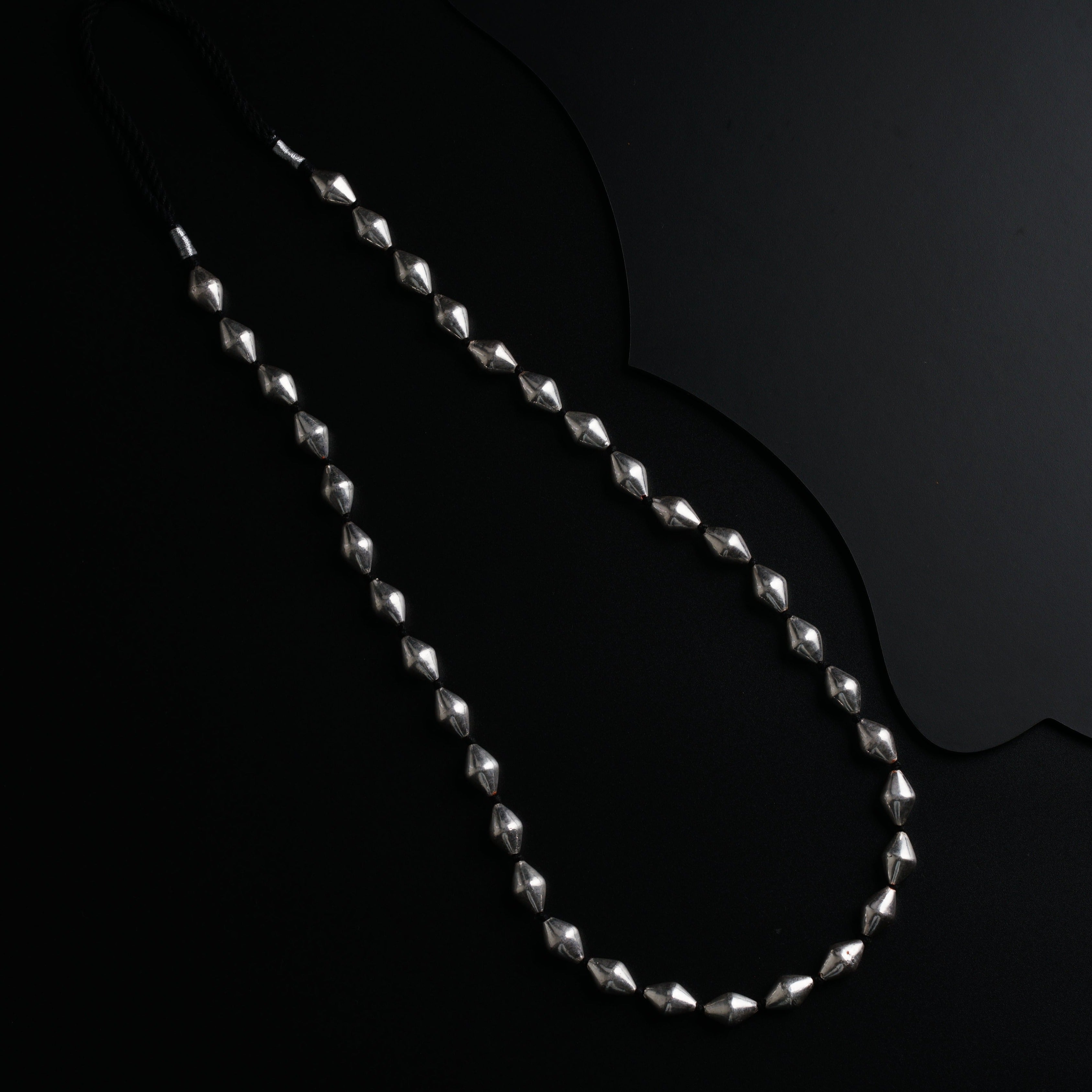 a long silver chain with a black background