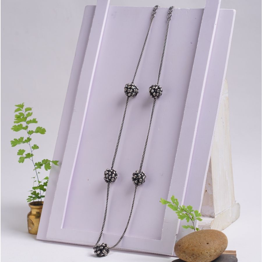 a set of three necklaces sitting on top of a table