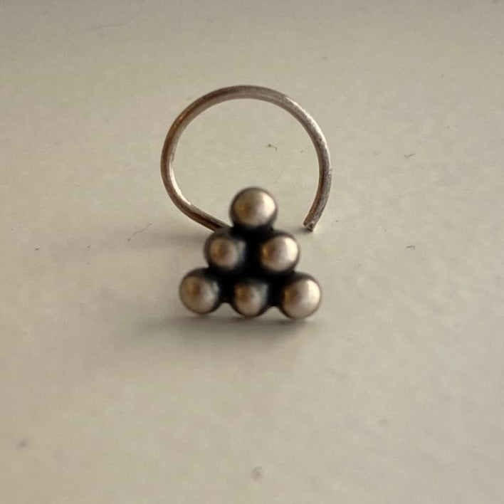 a silver ring with four balls on it