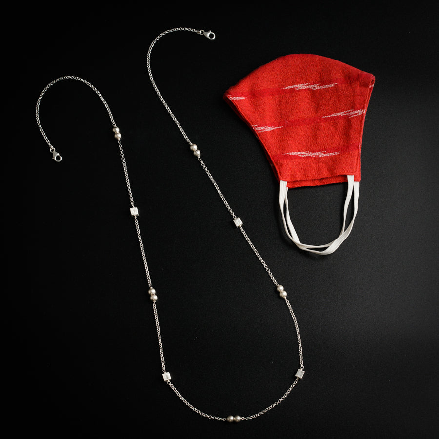 a necklace with a red hat on top of it