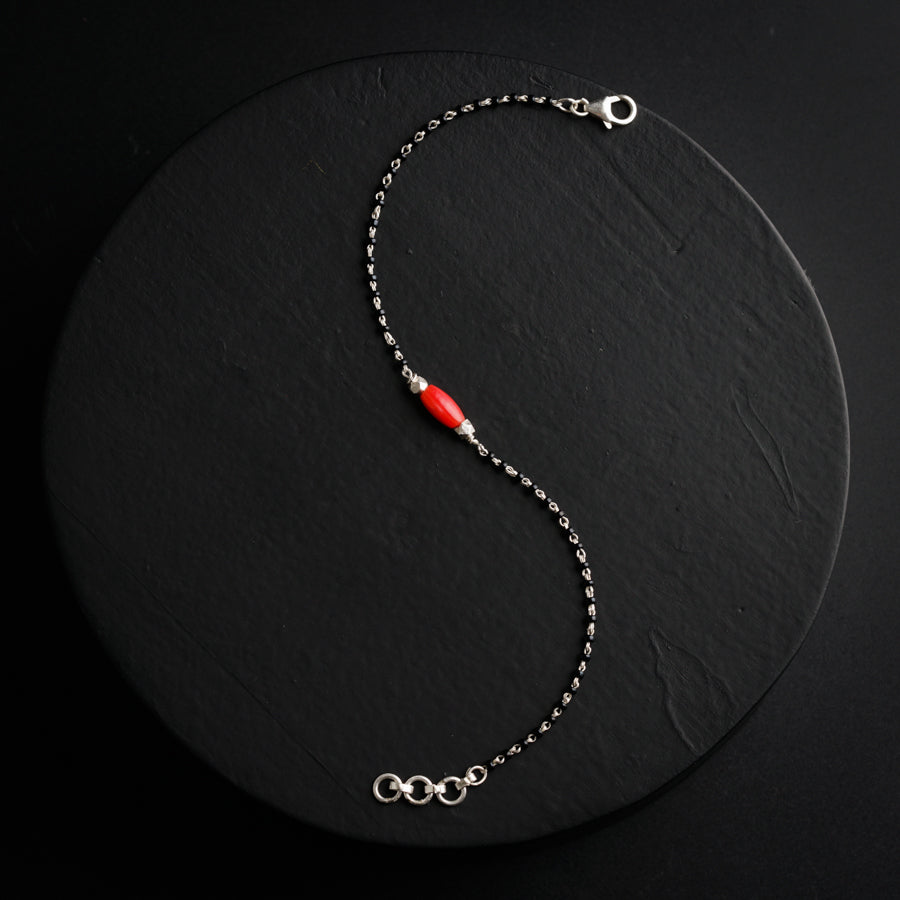 a red beaded necklace on a black background