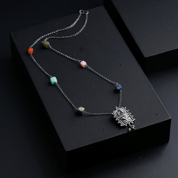 a black box with a necklace on it