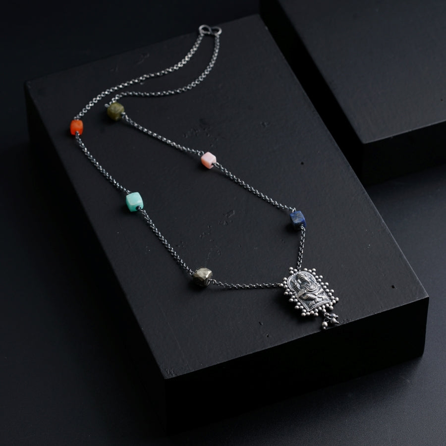 a black box with a necklace on it
