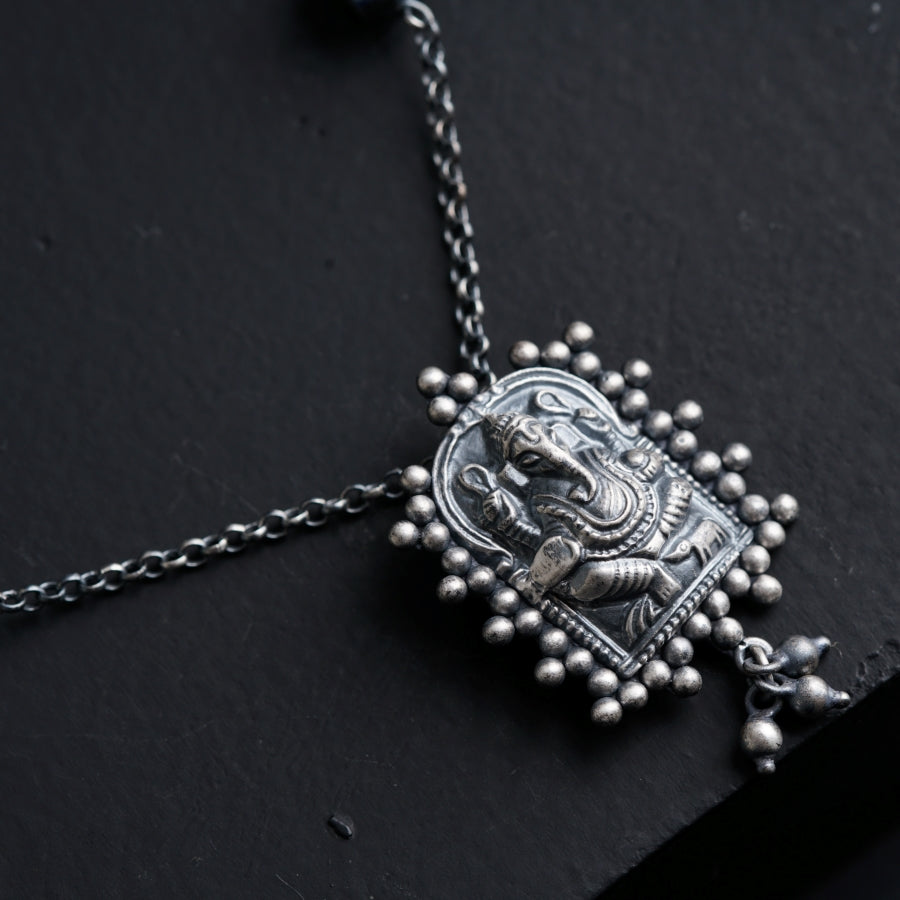 a close up of a necklace on a black surface