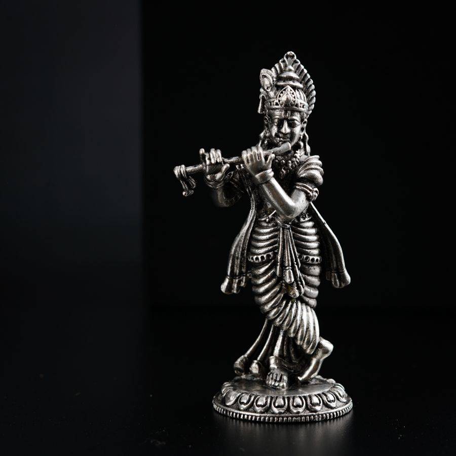 a statue of a man playing a flute