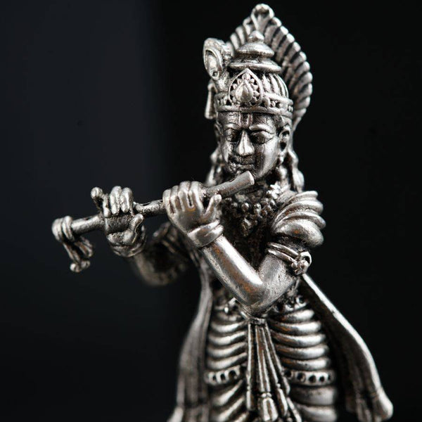a statue of a man playing a flute