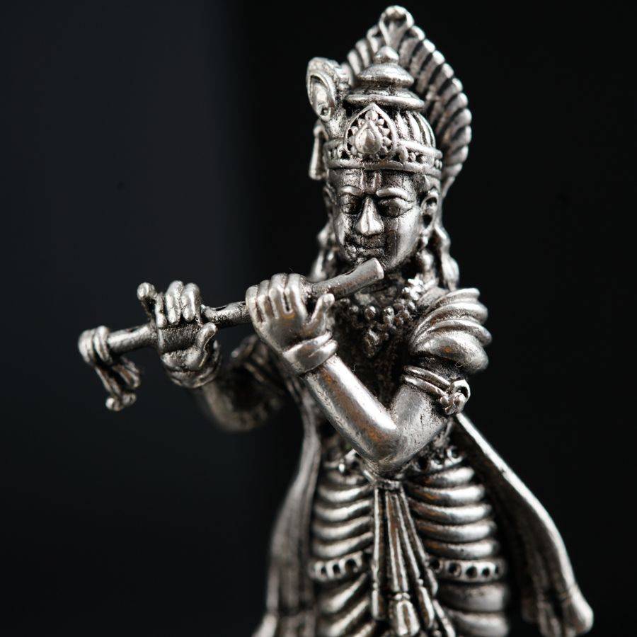 a statue of a man playing a flute