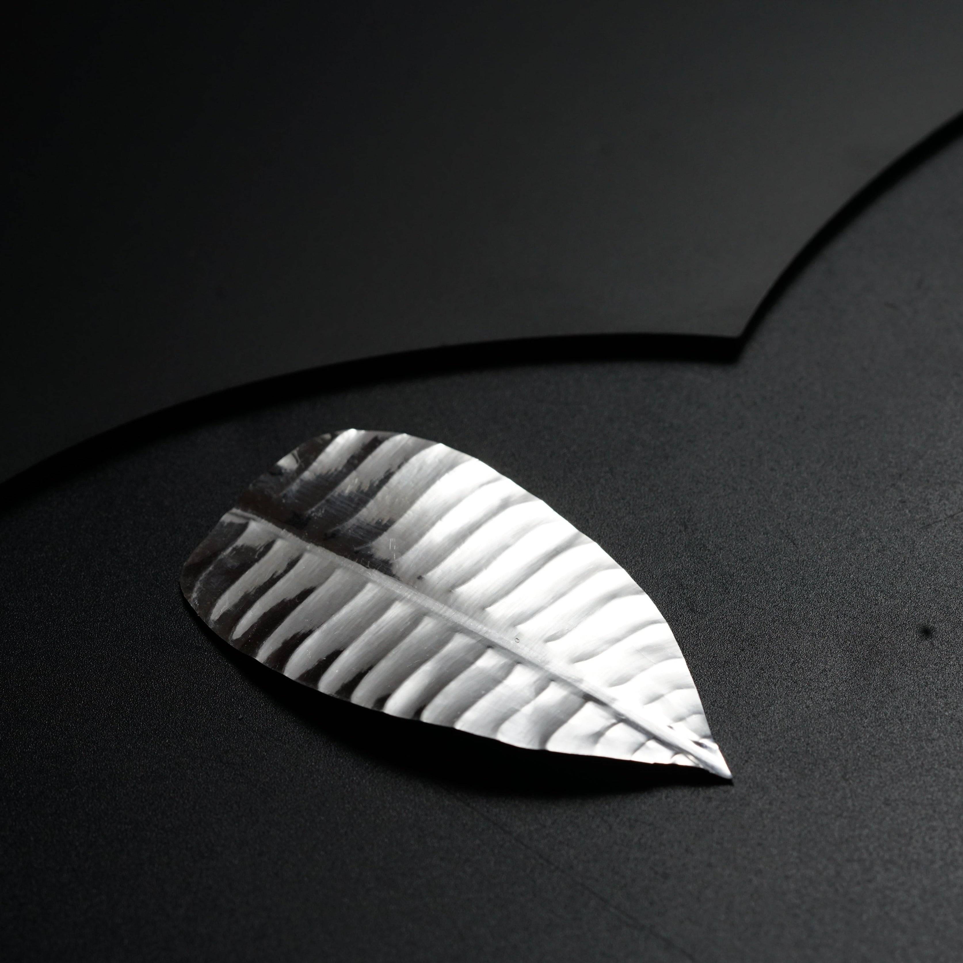 a piece of paper that has a leaf on it