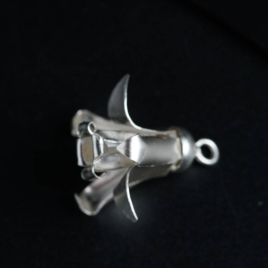 a metal object on a black surface