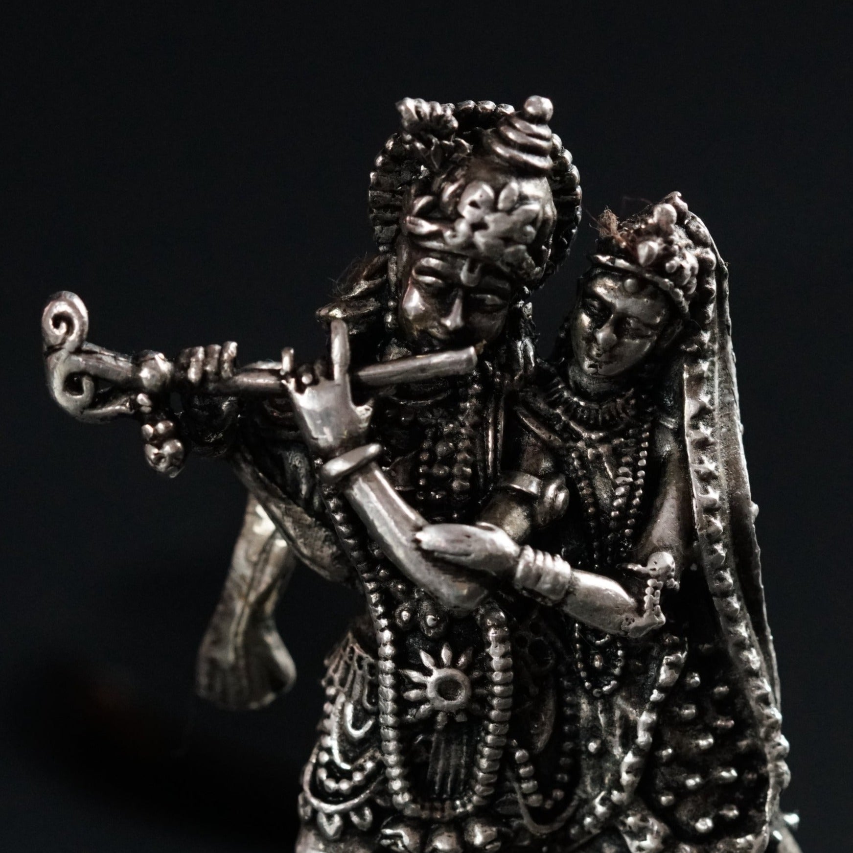 a statue of a man playing a flute