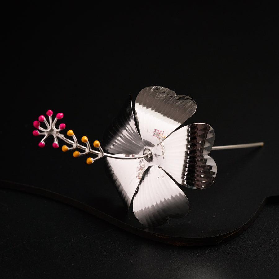 a metal object with a flower on top of it