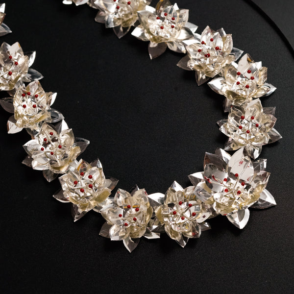 a close up of a necklace on a black surface