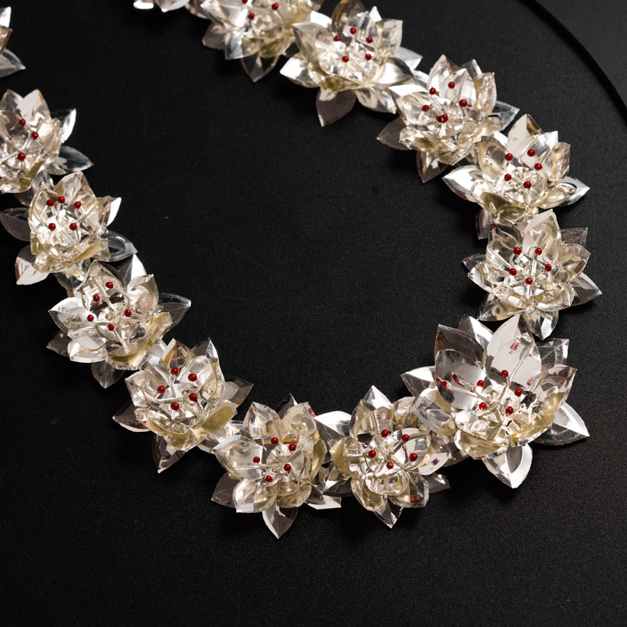 a close up of a necklace on a black surface