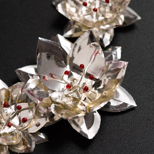 a group of crystal flowers on a black surface