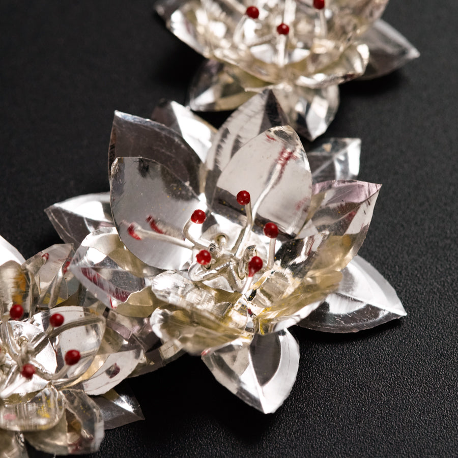 a group of crystal flowers on a black surface