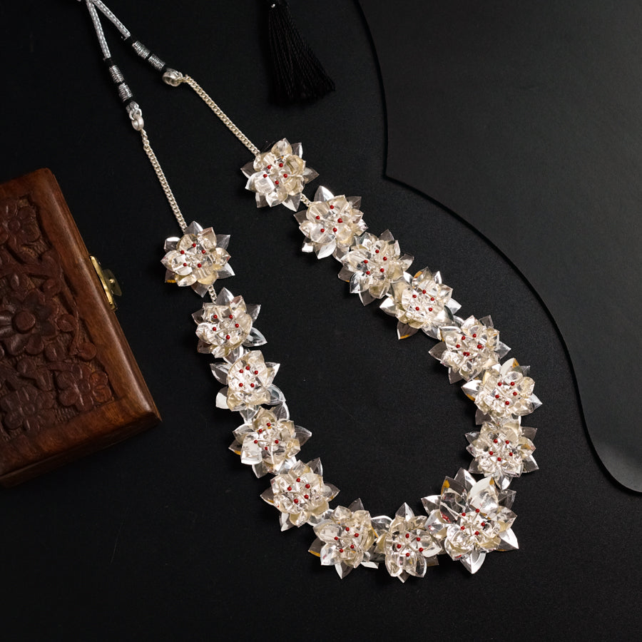 a close up of a necklace on a table