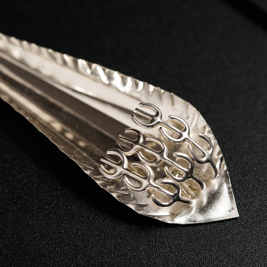 a metal fork with a design on it