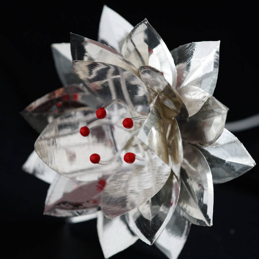 a close up of a paper flower on a table