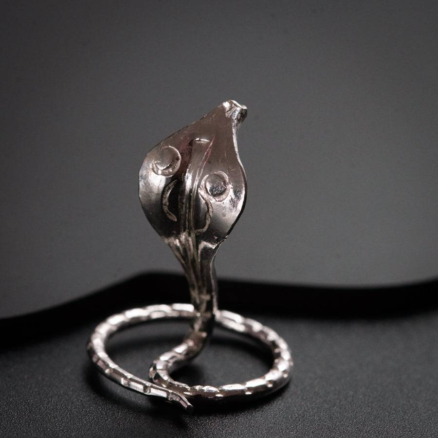 a silver ring with a flower on top of it