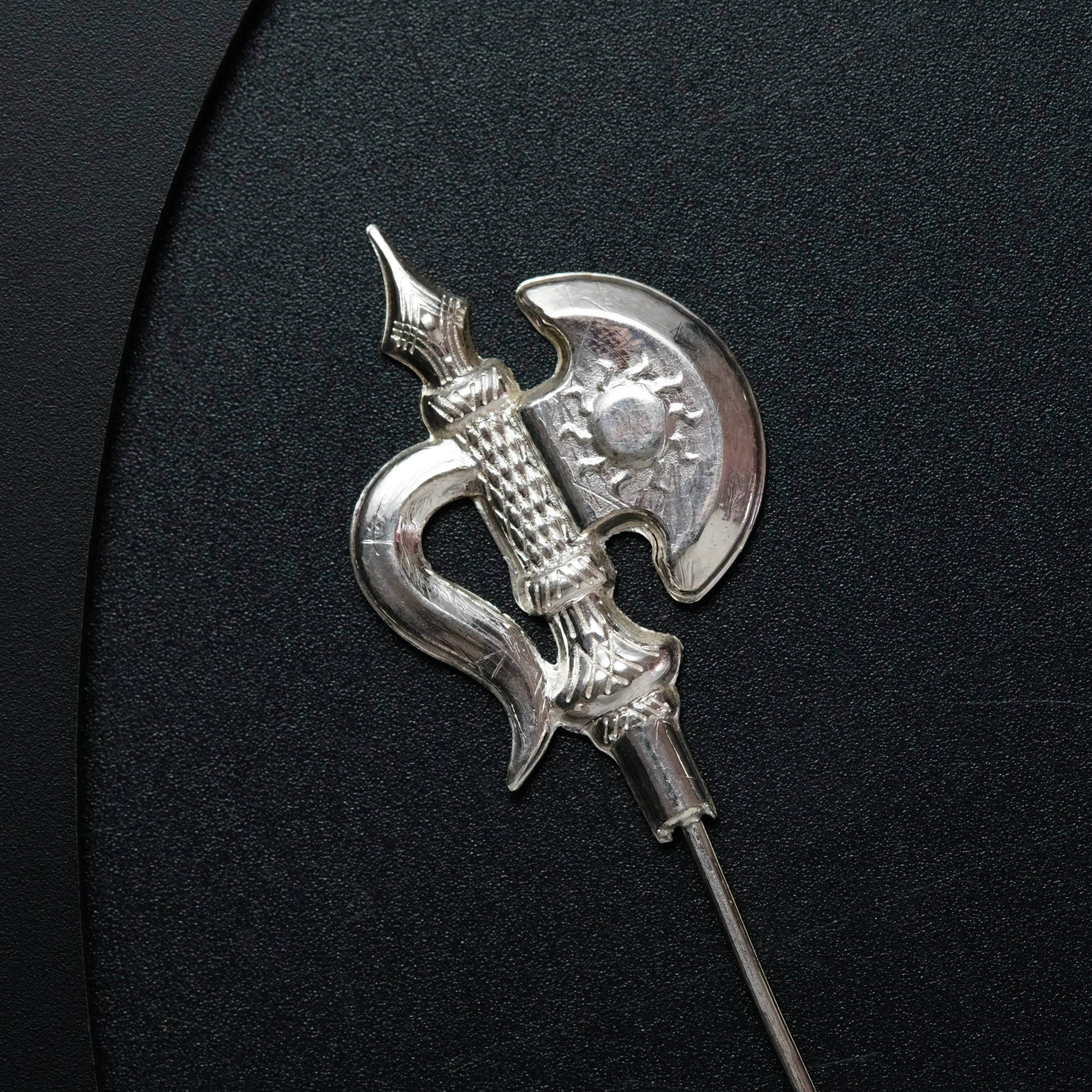a close up of a metal object on a black surface