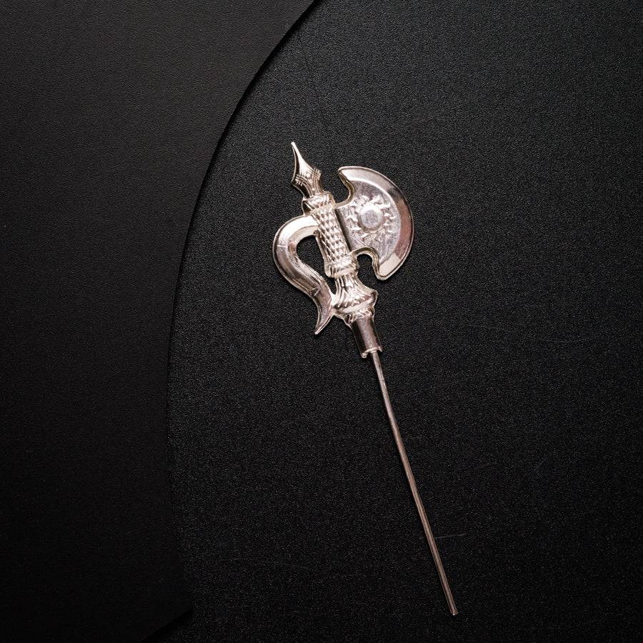 a silver brooch with a long metal handle