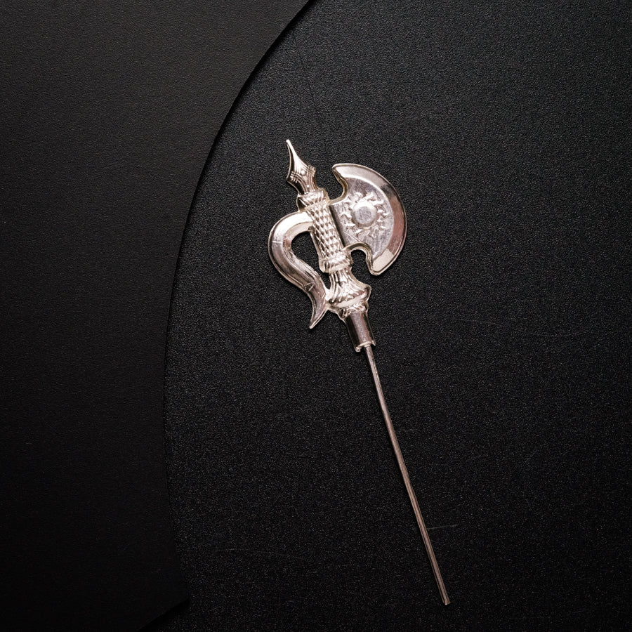 a silver brooch with a long metal handle