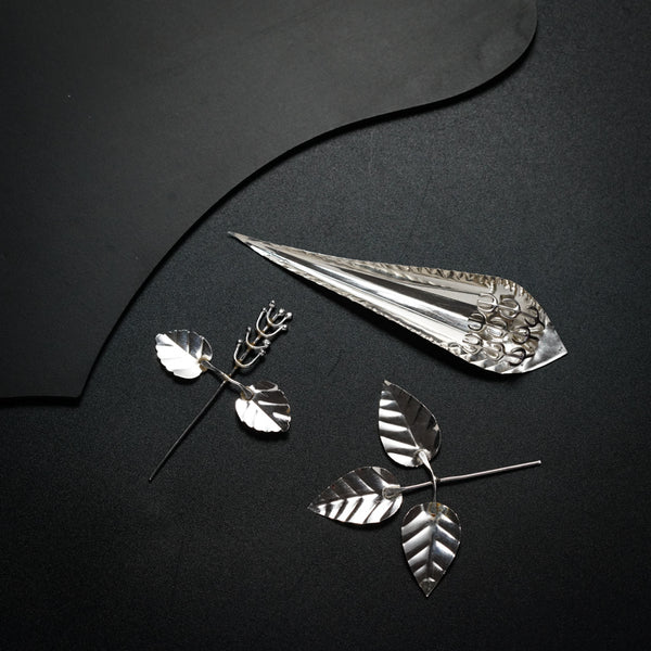 a pair of scissors and a pair of leaves on a table