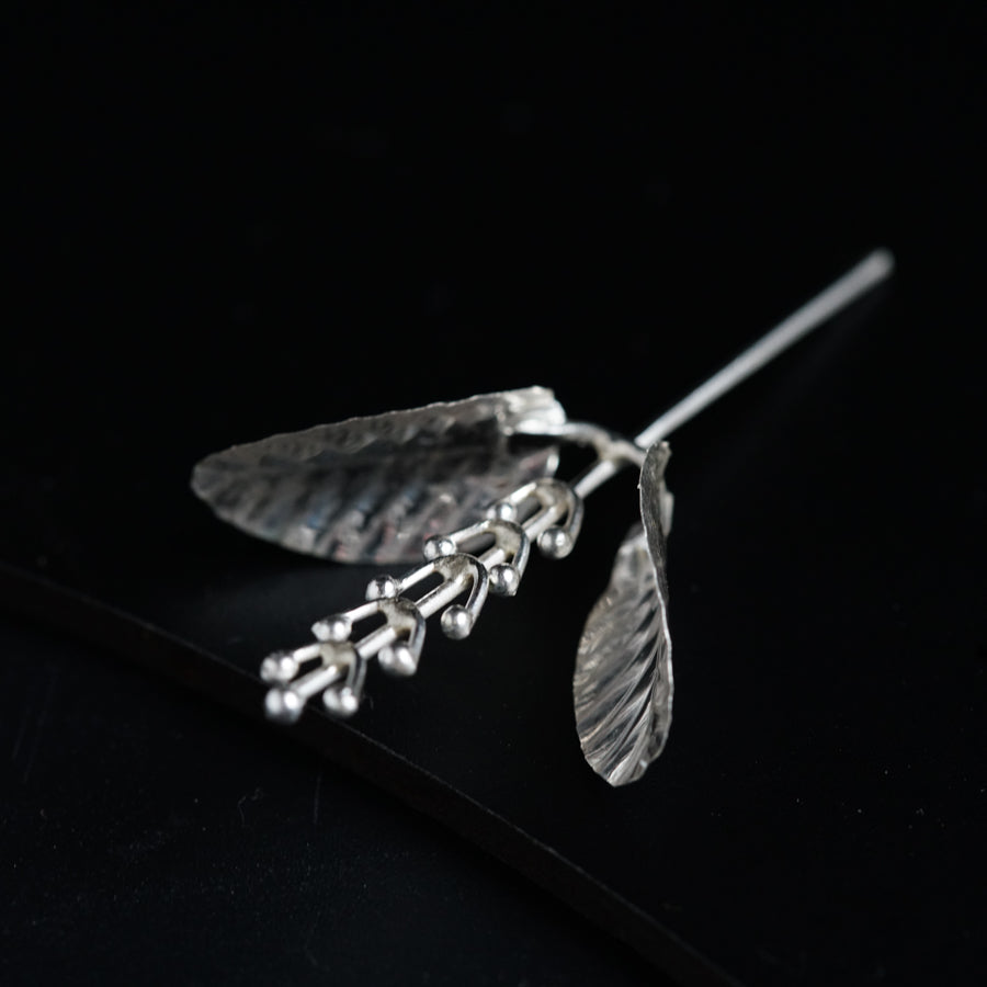 a close up of a metal object on a black surface