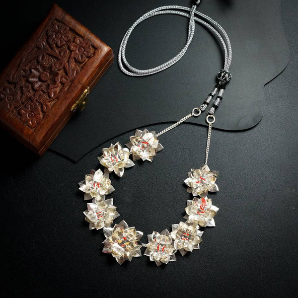 a necklace and a wallet on a table