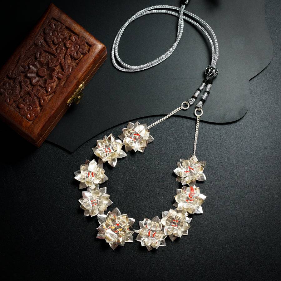 a necklace and a wallet on a table
