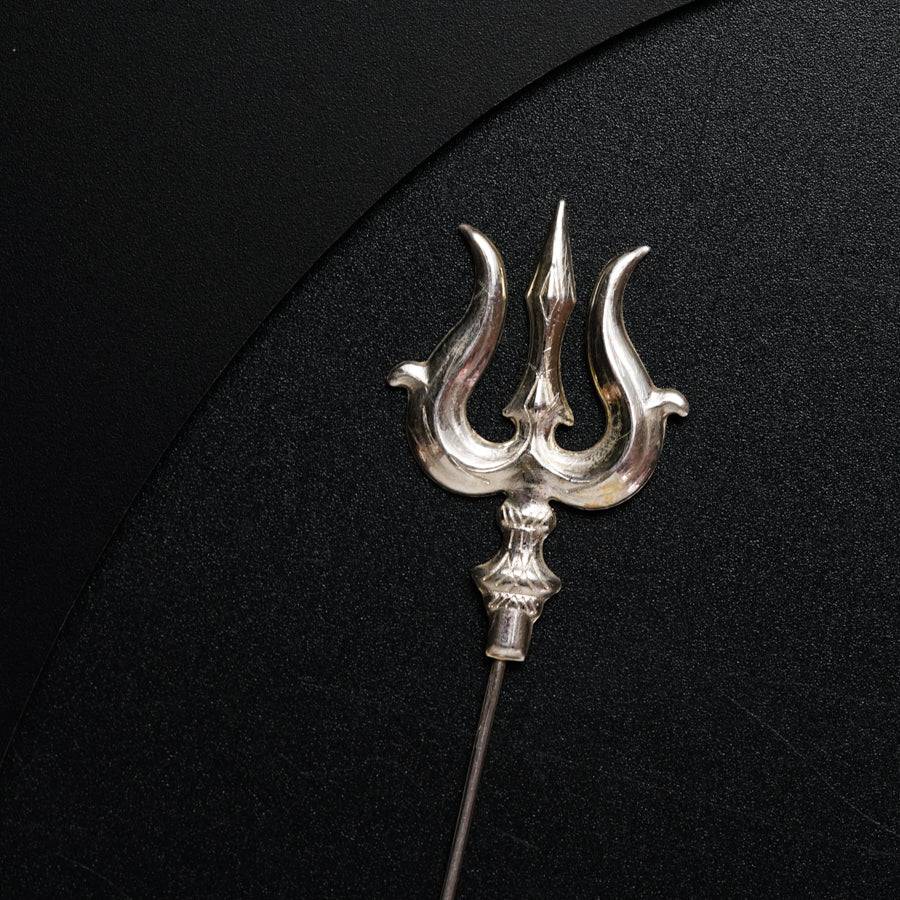 a metal object on a black surface