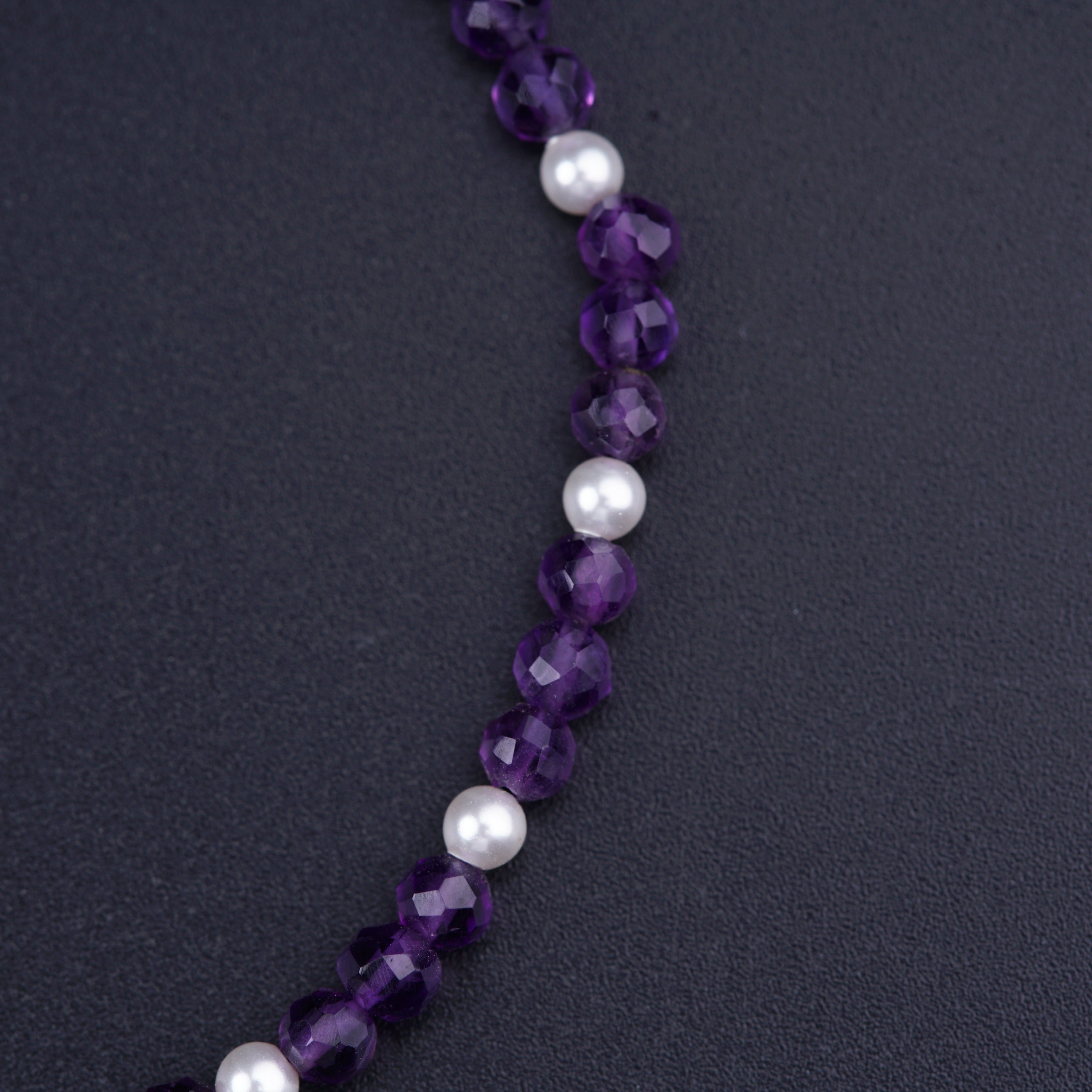 a necklace with pearls and amethyst beads
