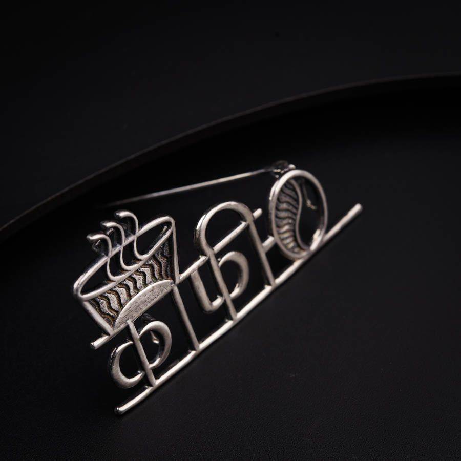 a close up of a metal object on a black surface