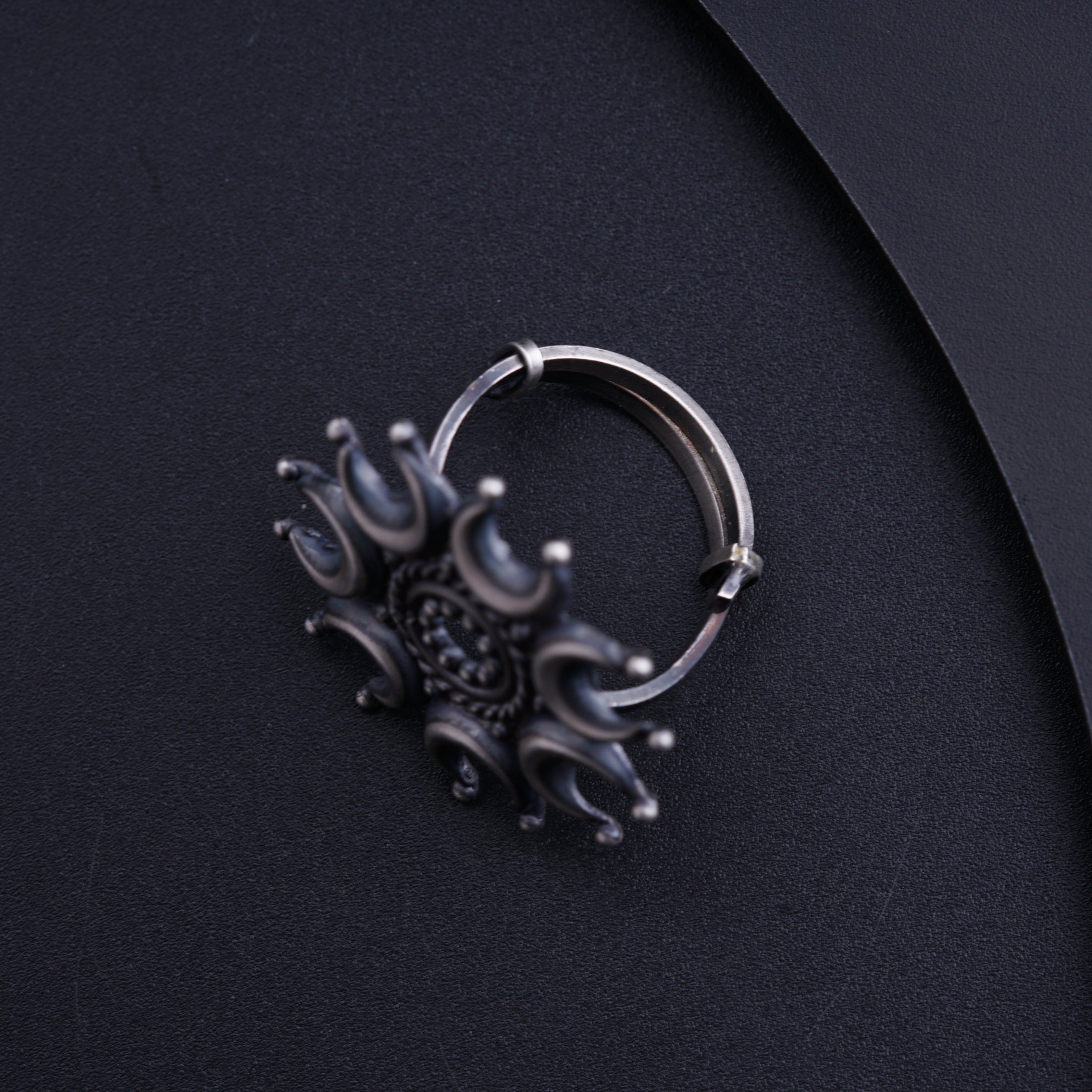a close up of a ring on a black surface