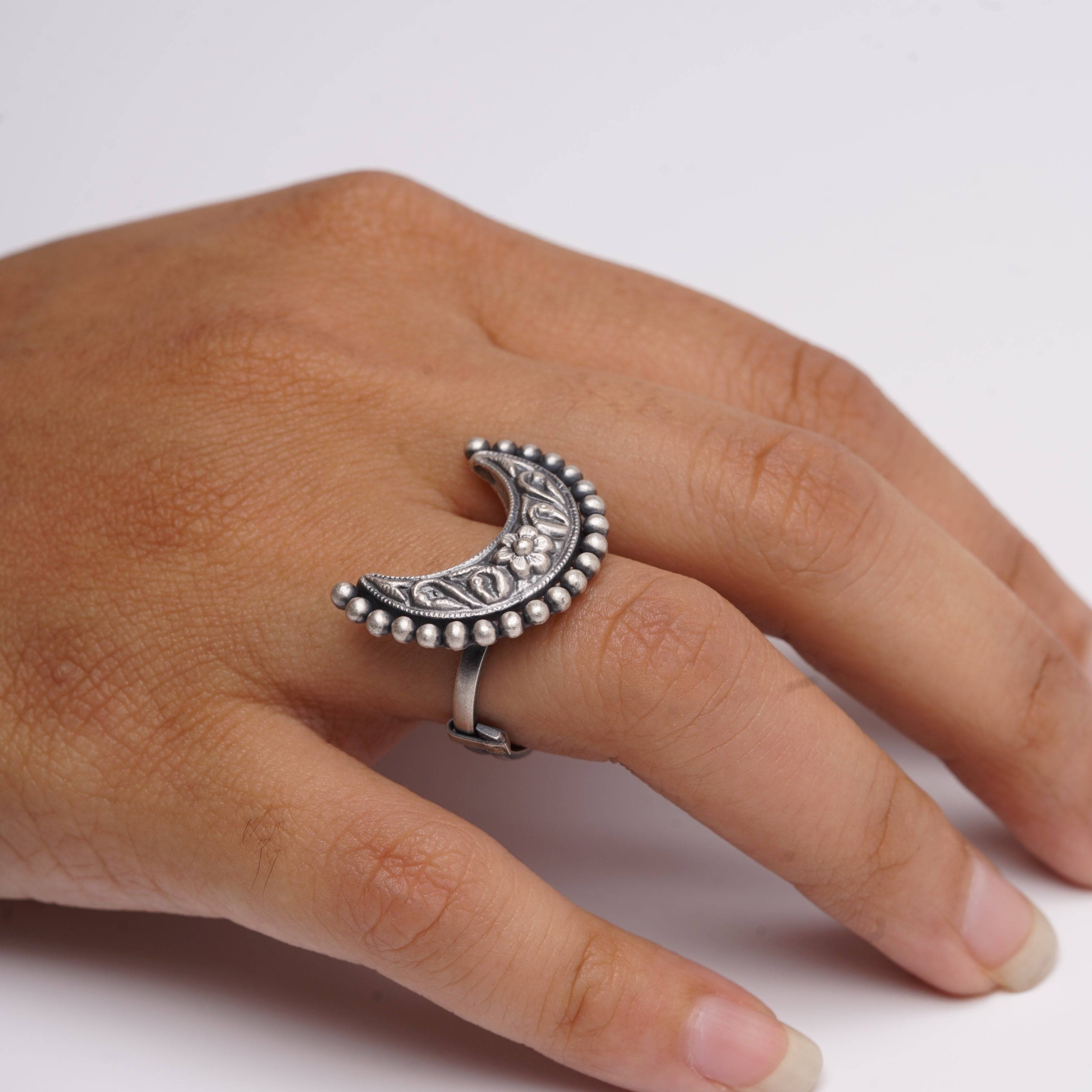 a person's hand with a ring on it