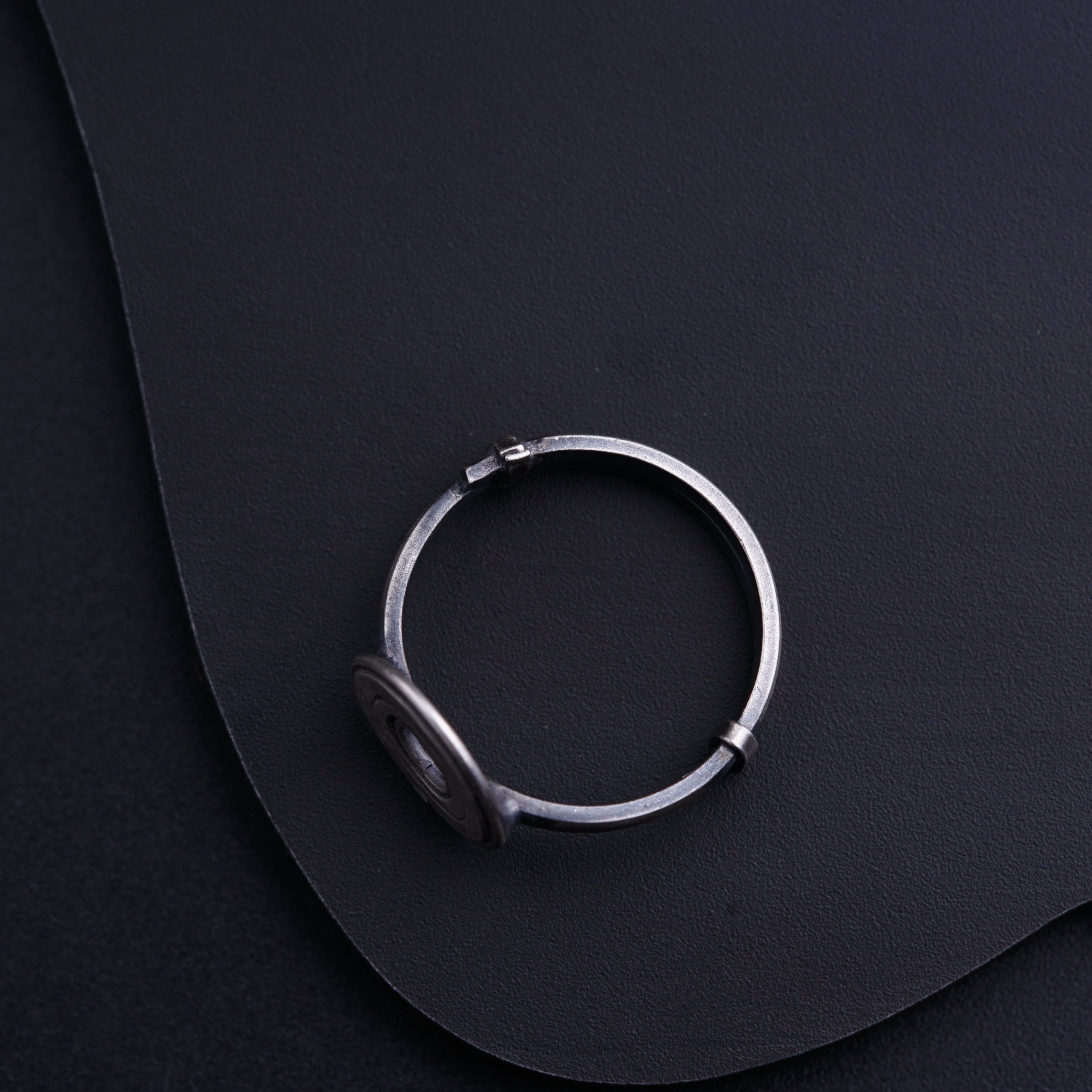 a close up of a ring on a black surface