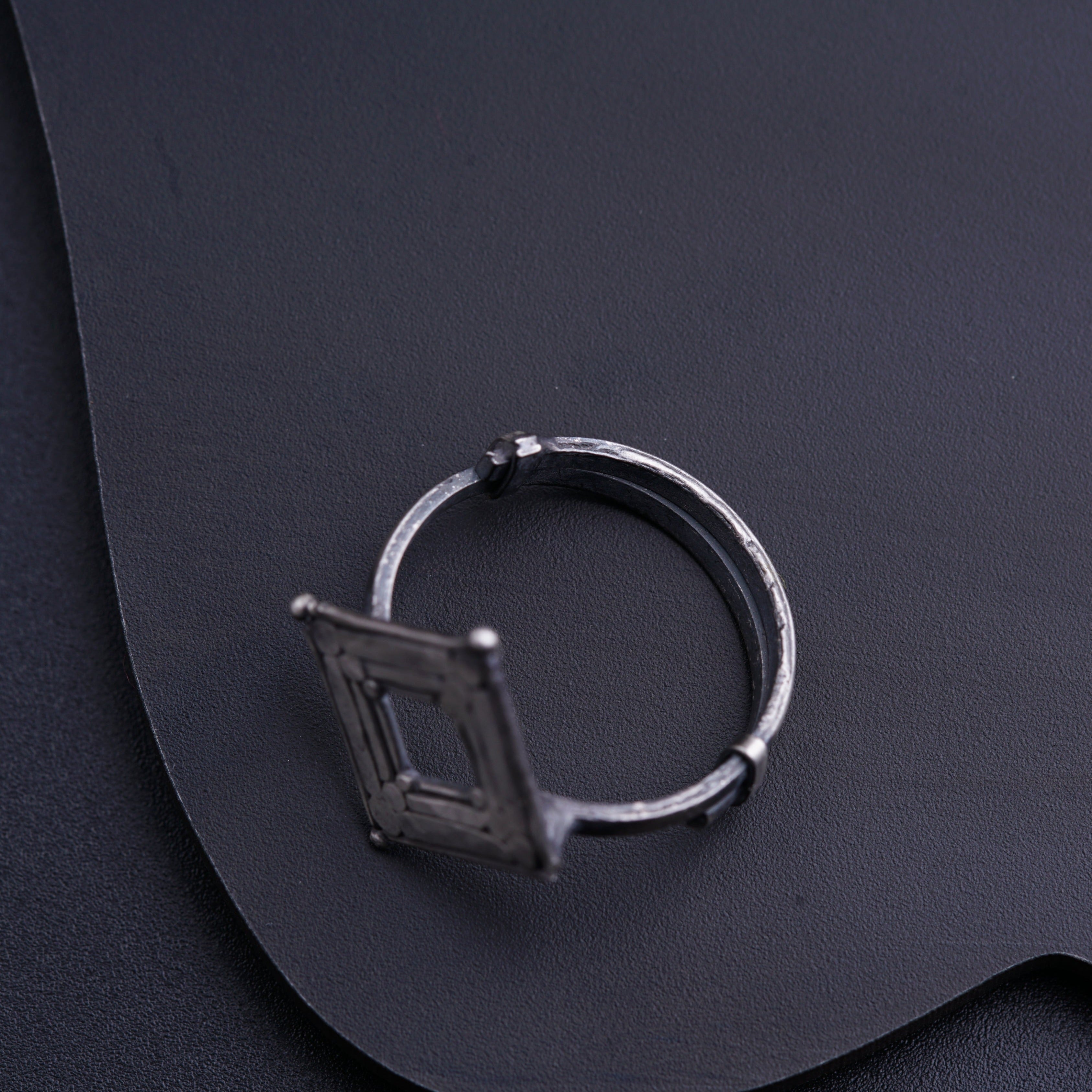 a ring sitting on top of a black surface